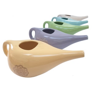 May include: Set of five ceramic nasal irrigation pots in various pastel colours, including yellow, lavender, green, blue, and white. Each pot has a decorative design and a spout for pouring.