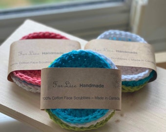 May include: Three sets of handmade cotton face scrubbies, each set includes three scrubbies in different colours. The scrubbies are packaged with a brown paper label that reads "Fur Lise Handmade 100% Cotton Face Scrubbles - Made in Canada".