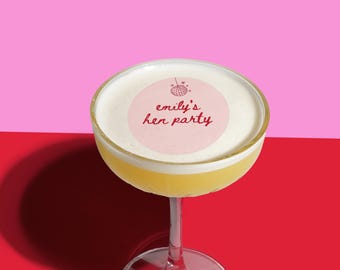May include: A cocktail in a martini glass with a pink circle sticker on top that says "emily's her party" with a disco ball icon.