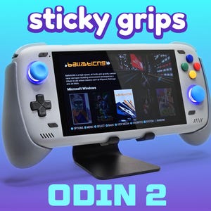 May include: A handheld gaming console with the text "sticky grips" and "ODIN 2" in a blue and purple gradient background. The console is white and gray with blue, green, yellow, and red buttons. The screen displays game screenshots.