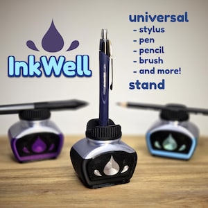 May include: Three InkWell stands in black, purple, and blue, each featuring a central holder for writing instruments. The text reads: InkWell, universal stylus, pen, pencil, brush, and more! stand. The stands have a drop-shaped emblem on the front.