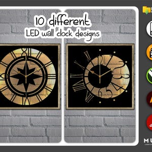 May include: Two black square frames with gold trim, each containing a different LED wall clock design. The clock on the left has a compass design with a gold star in the center. The clock on the right has a Roman numeral design with a gold sunburst pattern.