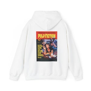 May include: White hooded sweatshirt with a graphic print of the Pulp Fiction movie poster featuring Uma Thurman and John Travolta. The poster has the text "Pulp Fiction" in red and yellow.