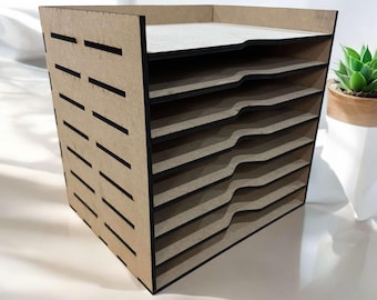 May include: A brown wooden paper organizer with eight shelves. The shelves have black edges and are slightly curved. The organizer has a grid pattern on the front.