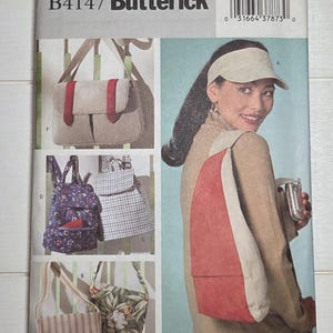 May include: A Butterick B4147 sewing pattern envelope featuring illustrations of various bag styles including a messenger bag with red straps, a floral backpack, a plaid backpack, a striped shoulder bag, a floral tote, and a sling bag.