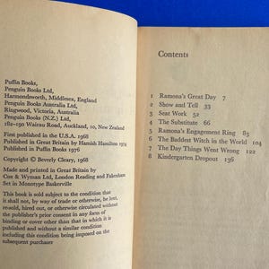 以下が含まれることがあります： テキストが書かれた開いた本のページ。1ページには、出版社や著作権などの出版情報が記載されています。向かい合ったページには、章のタイトルとページ番号が記載された目次が表示されています。