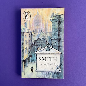 May include: A vintage paperback book titled "Smith" by Leon Garfield. The cover features an illustration of a city scene with a large building and a person walking. The Penguin logo is in the upper left corner.