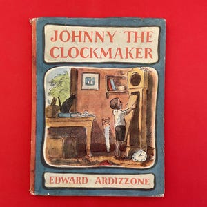 May include: Vintage children's book titled "Johnny the Clockmaker" by Edward Ardizzone. The cover features a detailed illustration of a young boy working on a clock, with a black cat on a table. The book has a blue border and a red background.