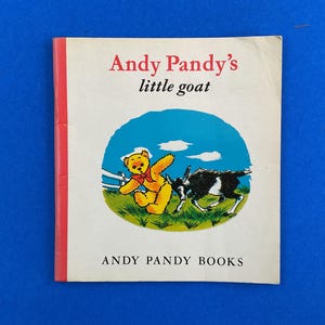May include: Vintage children's book titled "Andy Pandy's little goat." The cover features a cartoon illustration of a yellow teddy bear and a black and white goat in a grassy field under a blue sky. The book is from "Andy Pandy Books."