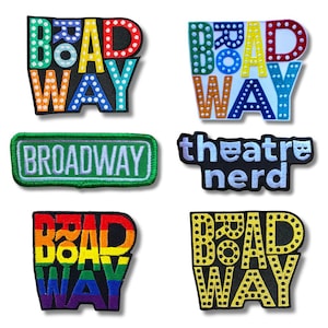 May include: A collection of embroidered patches with the word "Broadway" in various designs. Some patches feature colorful text, while others have a classic marquee style. One patch reads "theatre nerd".