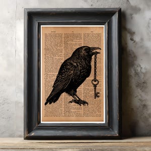 May include: Black framed art print depicting a black raven with a key in its beak. The raven illustration is set against a vintage dictionary page background. The artwork is framed in a black wooden frame.