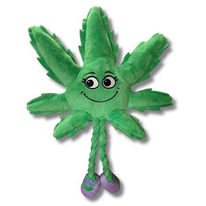 May include: Green plush toy shaped like a marijuana leaf with a smiling face and purple shoes. The toy has a rope tail.