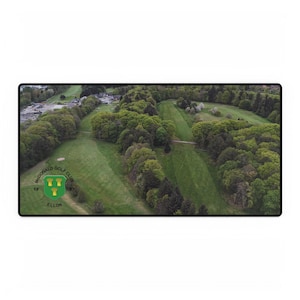 May include: A rectangular mousepad featuring an aerial view of a golf course with green fairways and lush trees. The mousepad includes the text "McDonald Golf Club" and a crest with the text "Ellon".