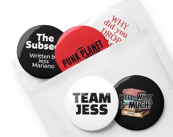 May include: A set of five round buttons with text and graphics. The buttons are black, red, and white. Text includes "The Subse", "PUNK PLANET MAGAZINE", "WHY did you DROP", "TEAM JESS", and "WELL, WHAT IS MUCH? HOWL". The buttons are in a white packet.