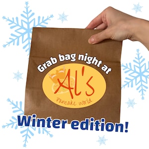 May include: A brown paper bag with the text "Grab bag night at Al's Pancake world" and "Winter edition!" in white and blue. The Al's logo is a yellow oval with orange and red text and a pancake graphic. A hand holds the bag.