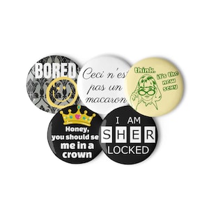 May include: A collection of five round buttons with various designs and text. One button says "BORED" with a smiley face, another says "Ceci n'est pas un macaron", and a third says "think. it's the new sexy". The other two buttons say "Honey, you should see me in a crown" and "I AM SHER LOCKED".