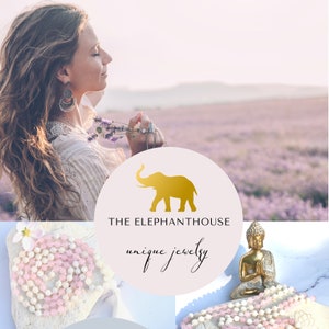 Può includere: Logo The Elephant House con silhouette di elefante dorato e la scritta «unique jewelry». L'immagine presenta una donna con lunghi capelli, gioielli e un mazzo di lavanda. Sotto ci sono collane e una statua dorata di Buddha.