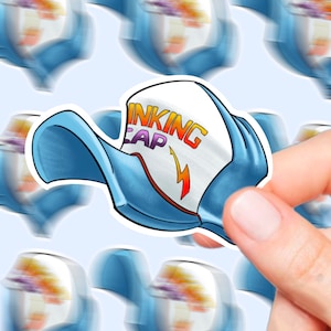 May include: A white baseball cap with a blue brim and a lightning bolt graphic. The cap has the text "Thinking Cap" in rainbow colours.