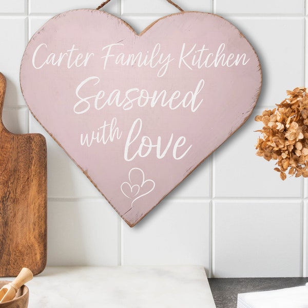 Personalized seasoned with love custom kitchen sign! Rustic antique style pink heart shaped solid wood sign with jute rope for hanging. 12"