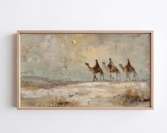 Op de afbeelding: Een rechthoekig ingelijst schilderij met drie figuren op kamelen in een woestijnlandschap onder een heldere gouden ster. Het kunstwerk heeft een gedempt kleurenpalet van beige, zandkleur en zachtgrijs met zichtbare penseelstreken.