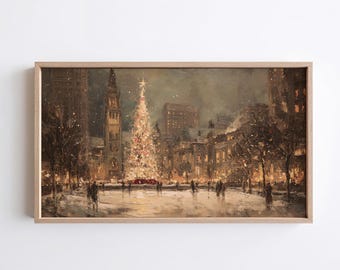 May include: A rectangular framed wall art print depicting a snowy city square at night. A tall, brightly lit Christmas tree stands in the center, surrounded by dark buildings, bare trees, and silhouettes of people walking on the ground.