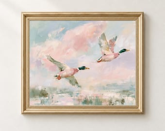 May include: A framed painting depicting two mallard ducks in flight against a soft, pastel-colored sky filled with pink and blue clouds. The ducks are rendered with visible brushstrokes, showing green heads and brown bodies, soaring above a muted landscape.