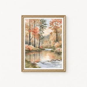 Könnte beinhalten: Ein gerahmter Wandkunstdruck mit einem Aquarellgemälde eines ruhigen Flusses, der im Herbst durch einen Wald fließt. Die Bäume zeigen leuchtend orangefarbenes, gelbes und grünes Laub, das sich auf der Wasseroberfläche spiegelt.