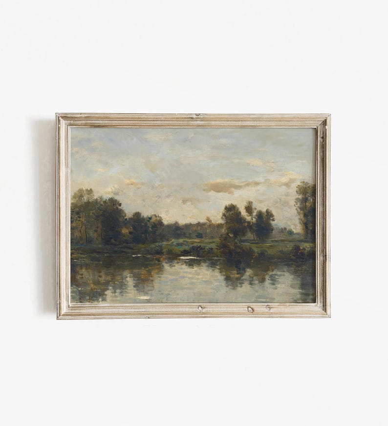 May include: A framed painting depicting a tranquil landscape with a river reflecting the cloudy sky. Lush green trees line the riverbanks, creating a serene and picturesque scene.