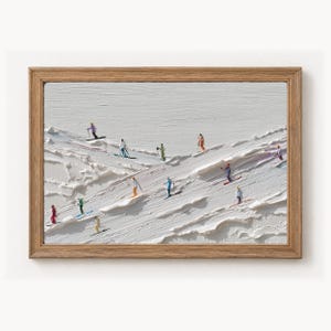 May include: A framed textured oil painting on canvas depicting a snowy mountain slope with multiple small figures skiing in various colourful outfits. The thick white impasto paint creates a three-dimensional effect of deep snow drifts and ridges.