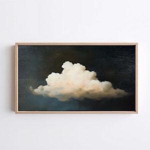 May include: A framed painting of a cloud against a dark background. The cloud is a fluffy white shape with soft edges, contrasting with the deep blue and brown hues of the sky. The frame is a light wood color.