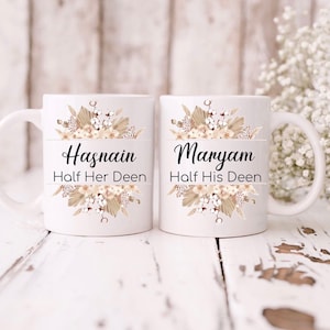 May include: Two white ceramic mugs with floral designs and the text "Hasnain Half Her Deen" and "Maryam Half His Deen".