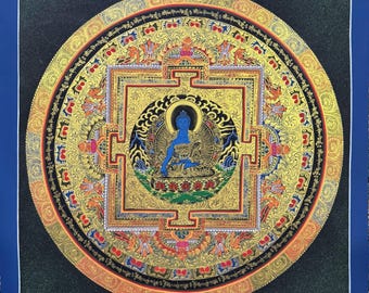 May include: A detailed, circular mandala painting with a blue border. The artwork features a central blue Buddha figure surrounded by intricate gold and colorful patterns. The design includes geometric shapes and ornate details, creating a visually rich and spiritual piece.