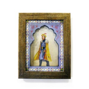 May include: A framed illustration of a man in a yellow and blue robe, wearing a red and gold hat, standing in a decorative archway.
