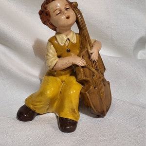 Joueur de violoncelle vintage en céramique