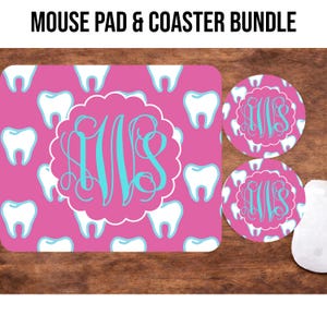 May include: A pink mouse pad and two coasters with a dental theme. The mouse pad and coasters feature a pattern of white teeth on a pink background. Each item has a teal monogram in a white scalloped frame. The text "MOUSE PAD & COASTER BUNDLE" is at the top.