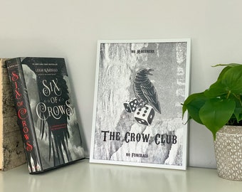 May include: A framed print of a black and white illustration of a crow with dice. The print has the text "The Crow Club" and "No Mourners, No Funerals".
