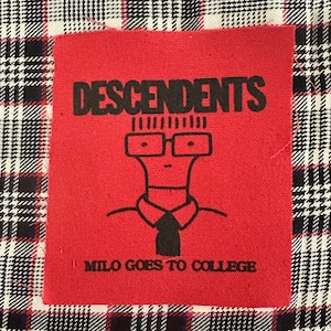 May include: Red fabric patch with black text and a cartoon illustration. The text reads "DESCENDENTS" and "MILO GOES TO COLLEGE".