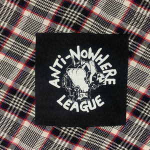 May include: Black and white patch with the text "Anti-Nowhere League" in a circle around a graphic of a hand holding a spiked club.