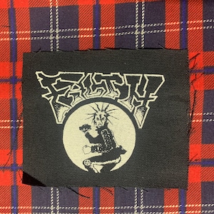 May include: Black and white embroidered patch with the word "FURY" in large, stylized letters above a circle containing a punk rock figure with a mohawk and an anarchy symbol.