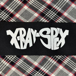 May include: Black patch with white text that reads "X-RAY-SPYX" in a stylized font.