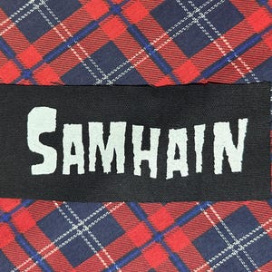 May include: Black fabric patch with the word "SAMHAIN" printed in white.