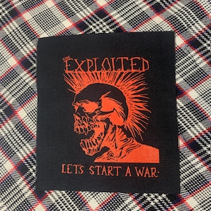 May include: Black and red embroidered patch with a skull with a mohawk and the text "The Exploited" and "Let's Start A War."