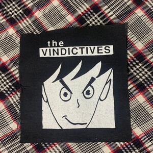 May include: Black and white iron-on patch with the text "the VINDICTIVES" and a cartoon face with a mischievous grin.