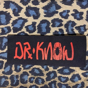 May include: Black patch with red text that reads "Dr. Know" with a red spider graphic.