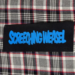 May include: A black patch with the words "SCREECHING WEASEL" in blue, stylized lettering. The patch is set against a plaid fabric background in black, white, and red.