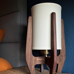 Walnut Lamp with White shade hand crafted with a Mid Century Modern design including brass hardware, premium cord, and Edison style bulb