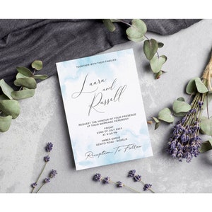 May include: A wedding invitation with a watercolor background in shades of blue. The invitation reads "Laura and Russell" and includes the date, time, and location of the wedding ceremony. The text "Reception to Follow" is also included.