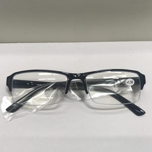 May include: Black rectangular reading glasses with clear lenses. The glasses have a +1.50 magnification.
