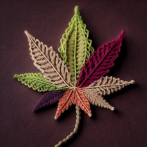 Pode incluir: Uma folha colorida feita de fio, com tons de verde, vermelho, roxo e laranja. A folha é costurada com um padrão detalhado.