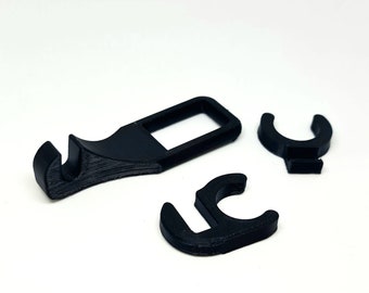 May include: Three black plastic pieces, one is a hook with a slot, the other two are C-shaped clips.